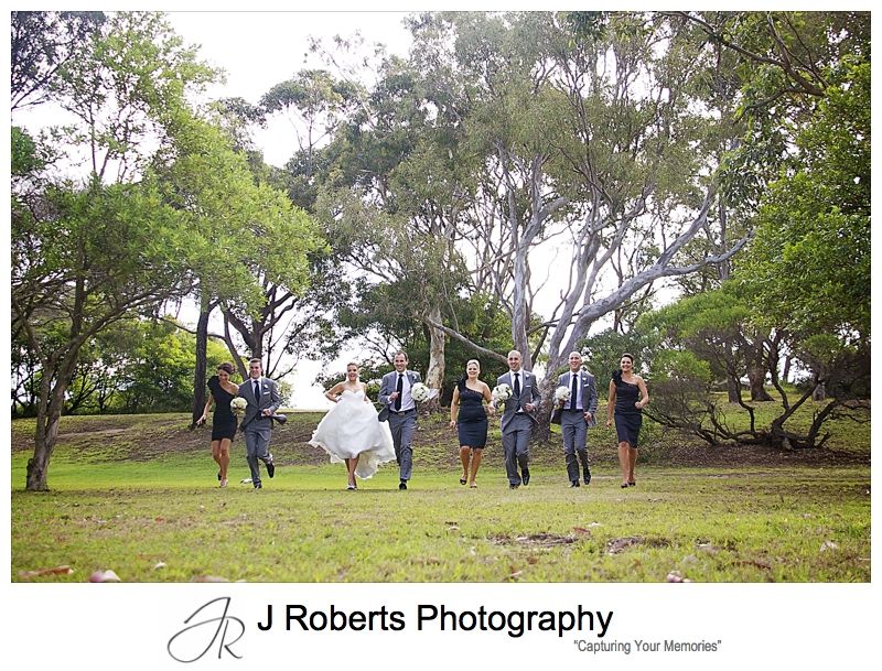 Bridal party having a running race - wedding photography sydney